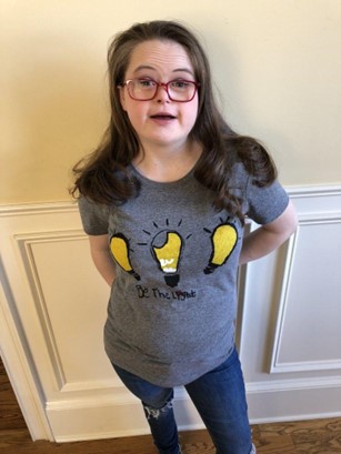 Girl wearing a gray Be The Light' Tee