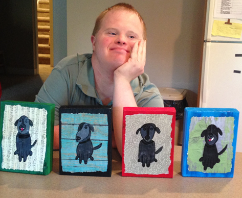 Bradley posing in front of four wooden leash holders