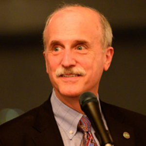 Photo of Arthur Ginsberg speaking at a microphone