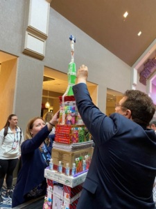 Participants building a skyscraper out of school supplies.