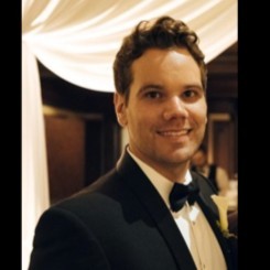 Photo of Ryan Henning, who has short, dark hair and is wearing a tuxedo
