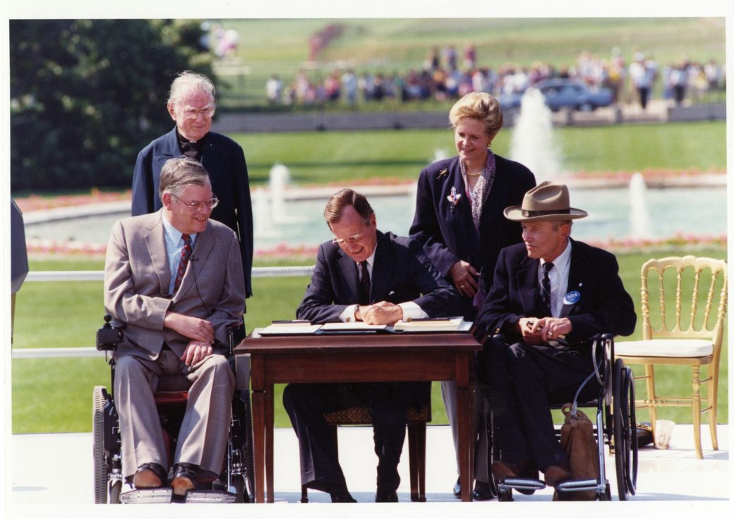 President George H.W. Bush signing the Americans with Disabilities Act.