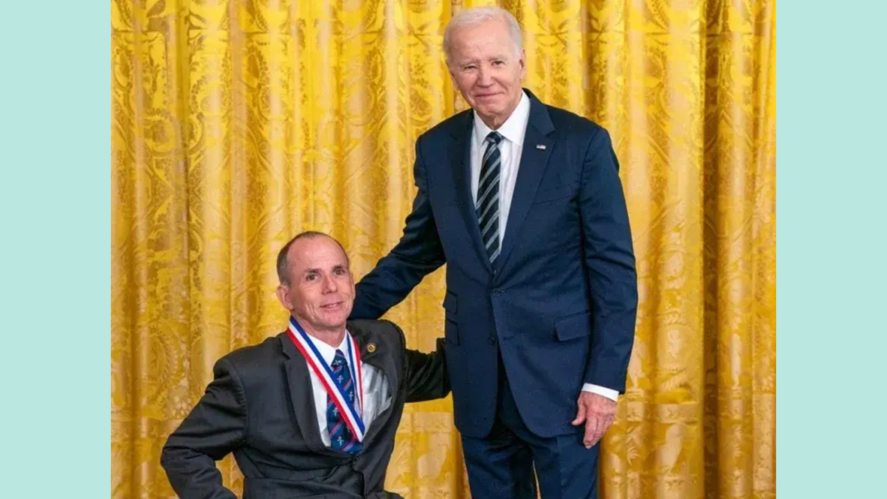 Dr. Rory Cooper accepting award from President Biden