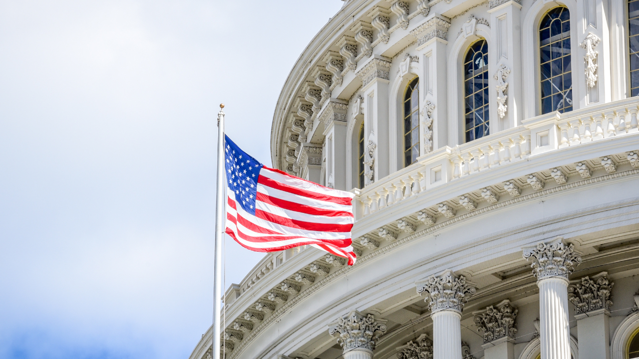 Close-up of the U.S. Capitol building and an American flag