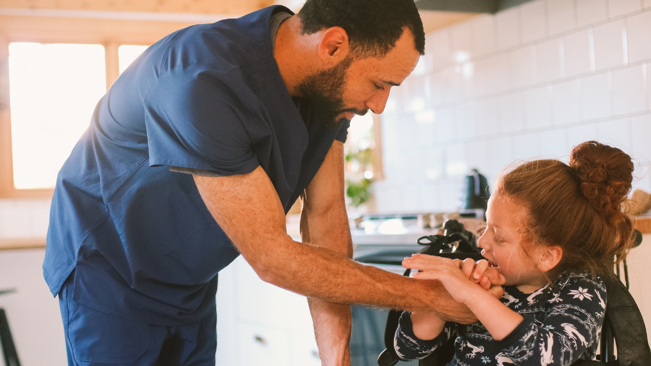 Health care worker supports a child with disabilities in her home.