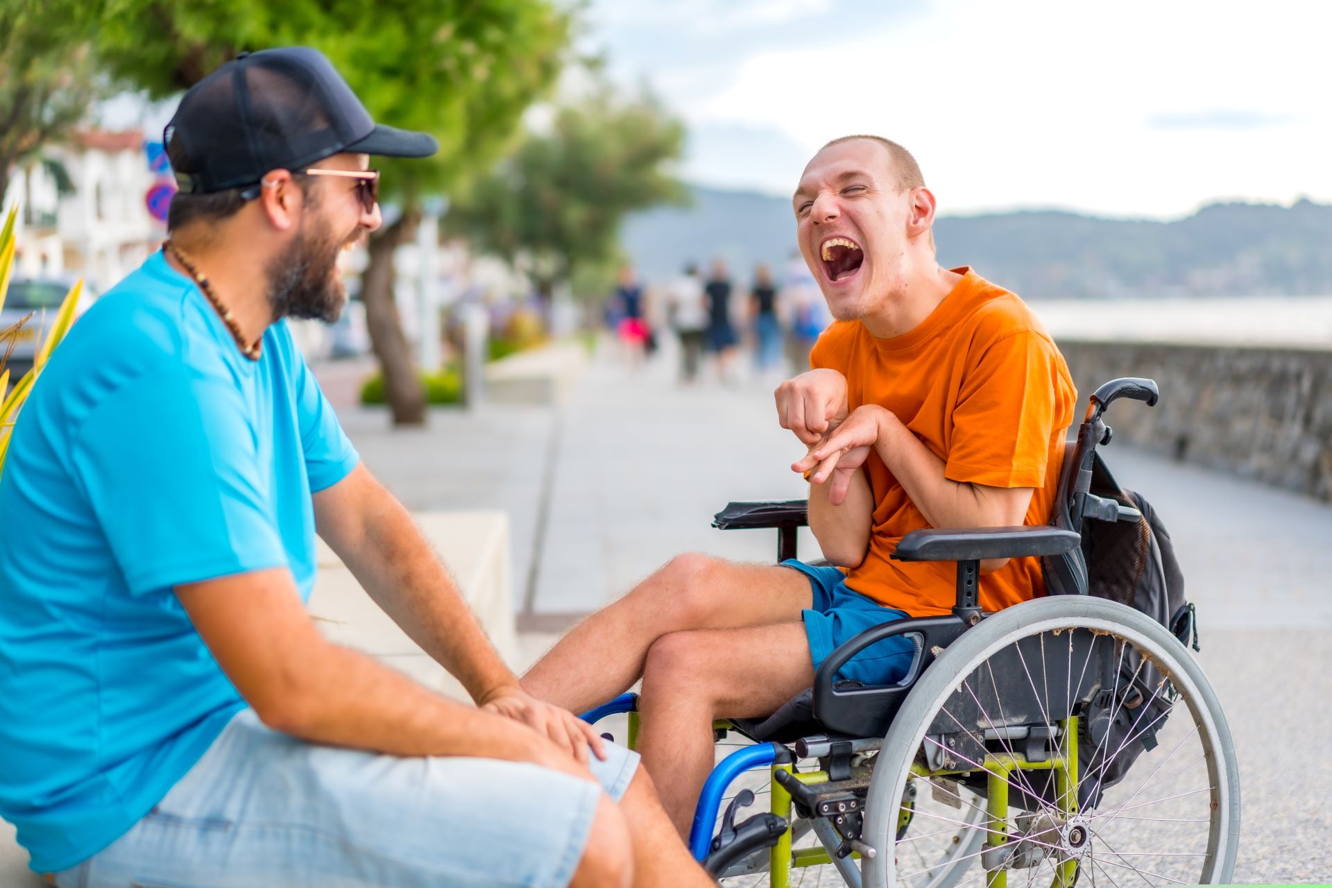 A person with disabilities and their support professional outside on a boardwalk