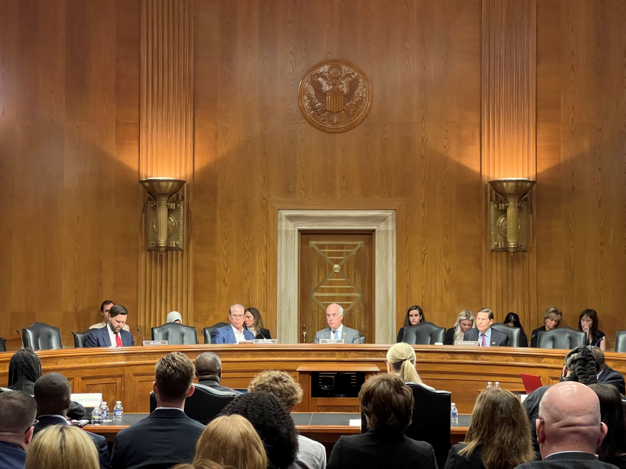 Senate Aging Committee Room with 4 Senators on the dais from left to right, Senator Vance, Senator Braun, Senator Casey, Senator Blumenthal. You can see the backs of audience members head in the foreground.