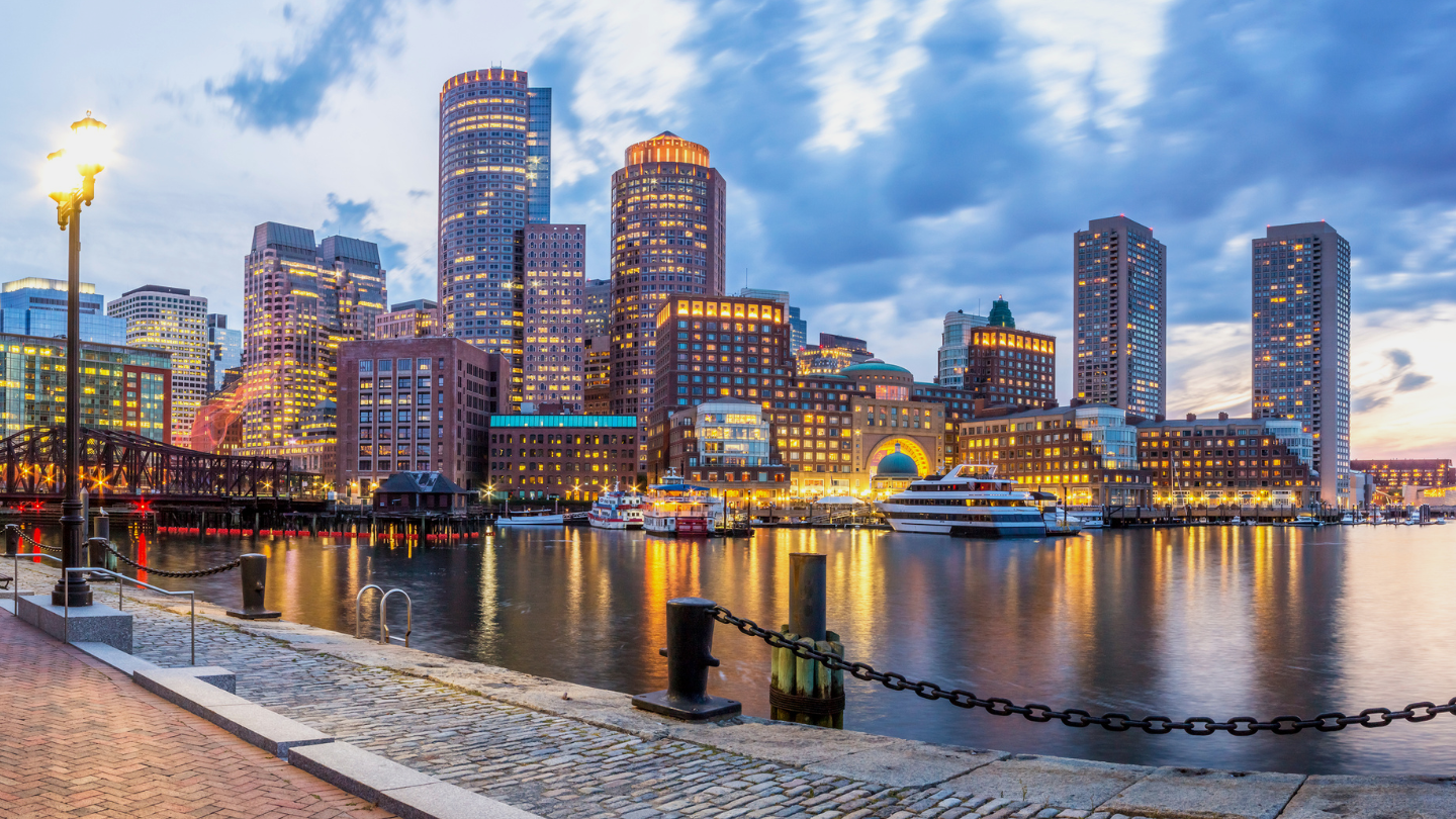 view of Boston's seaport district at sunset