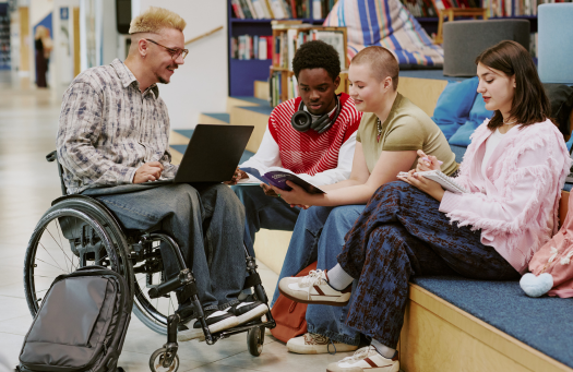 Stock photo of a group of people sitting in a semicircle, one in a wheelchair