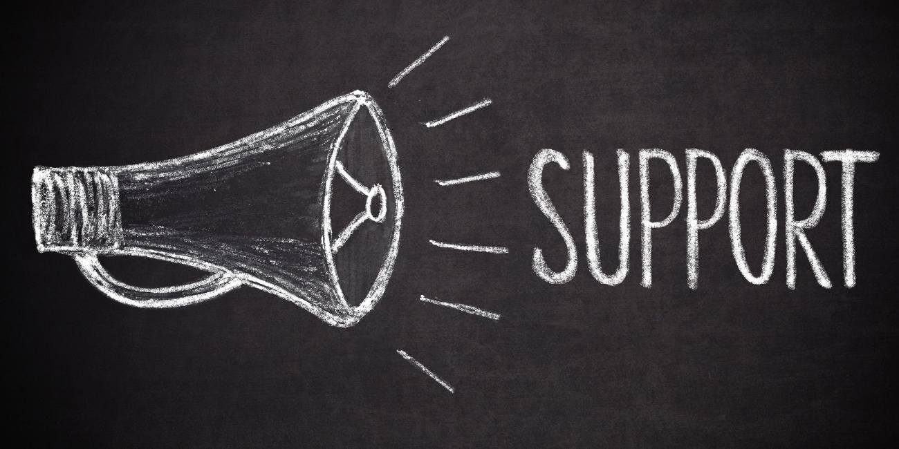 chalkboard that says support next to a megaphone