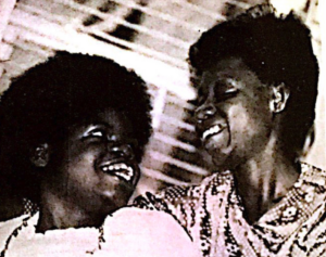Black and white photo of Gouverner Parents Association Founder Willie Mae Goodman (right) with her daughter Marguerite (left). The pair are looking at each other and smiling.