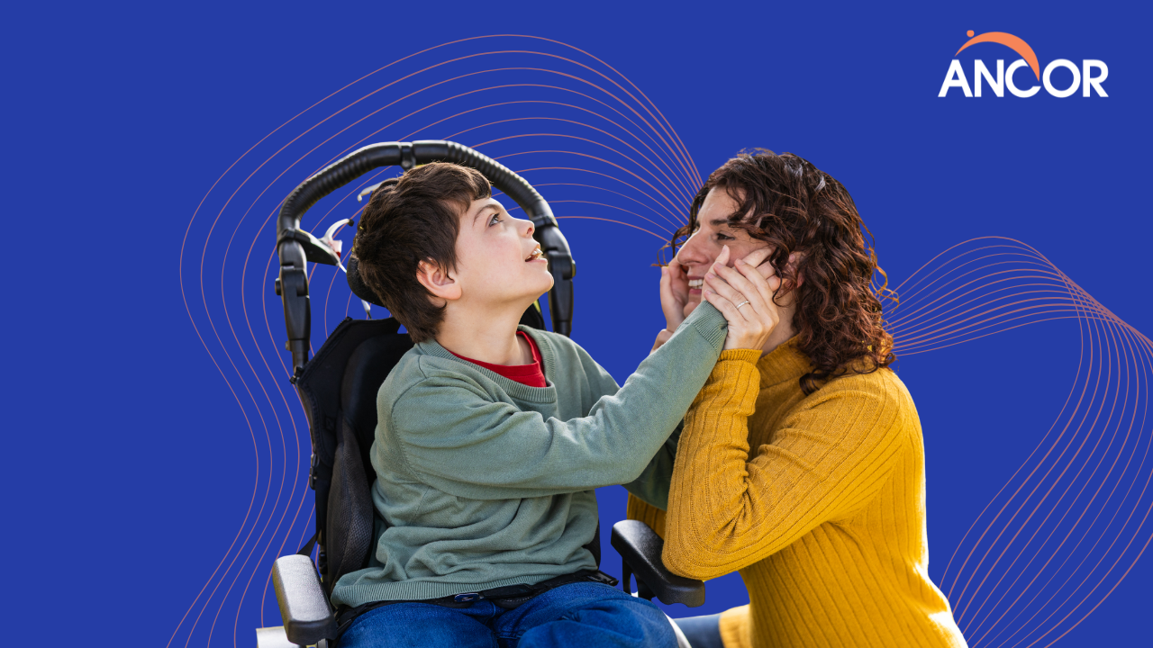 a child with I/DD using a wheelchair pictured next to his caregiver