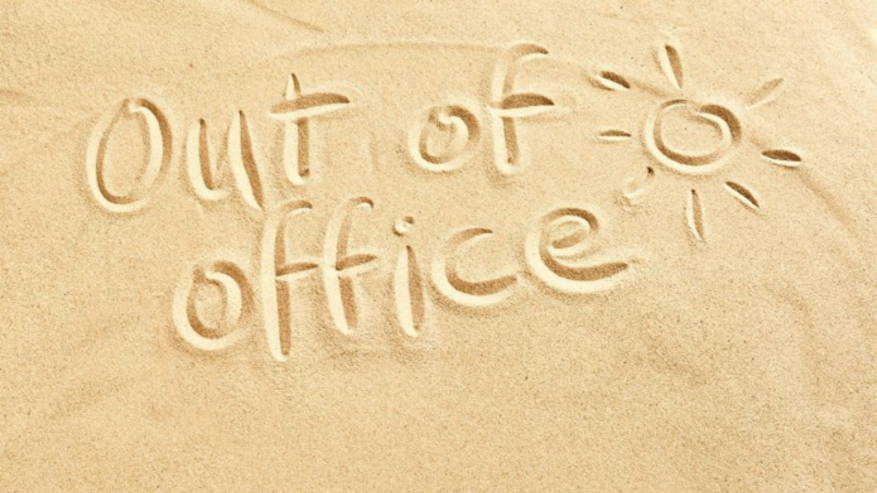 stock photo of 'out of office' and a sun written in sand
