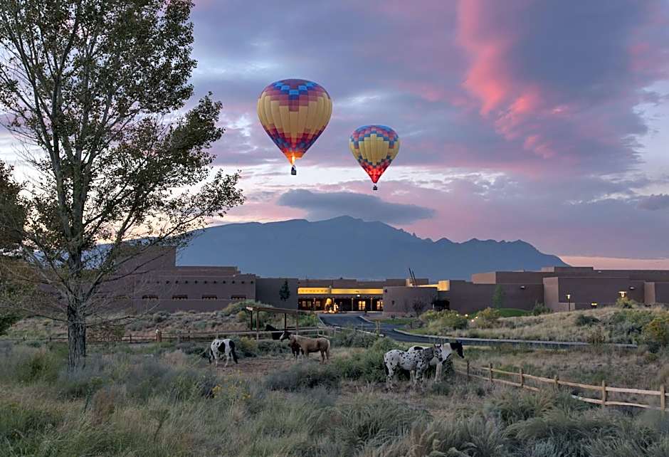 hot air balloons flying at sunset over the Santa Ana Pueblo
