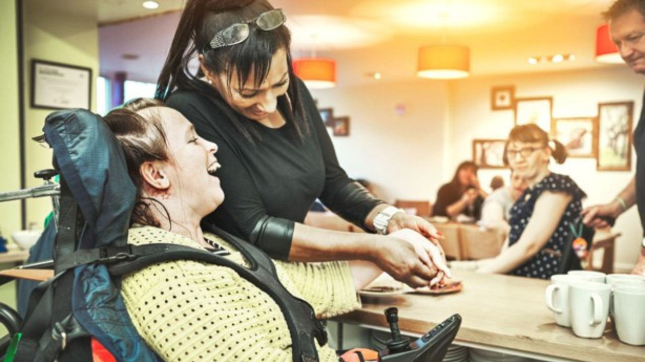 photo of a DSP helping a person using a mobility device