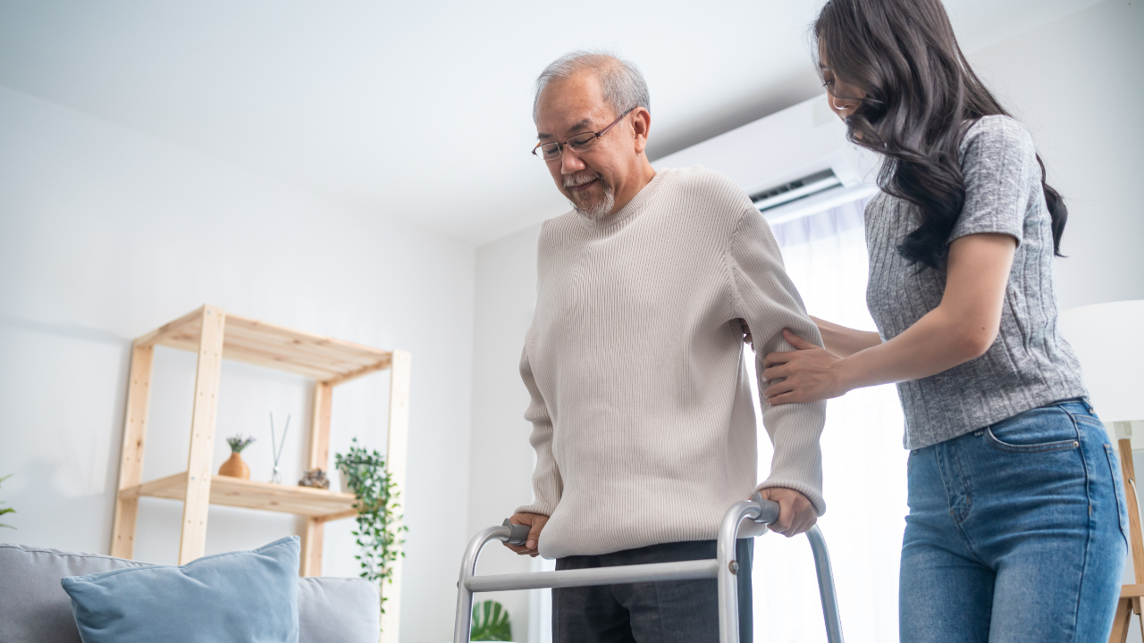 stock photo of person helping to stabilize person using a walker